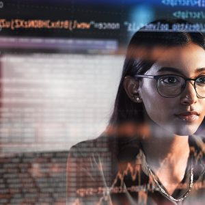 Pictorial representation of a woman analyzing a display with code, graphs, and various other characters.