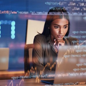 Pictorial representation of Gh0st RAT malware. A woman analyzes code on a computer screen in an office setting, with another individual working in the background.