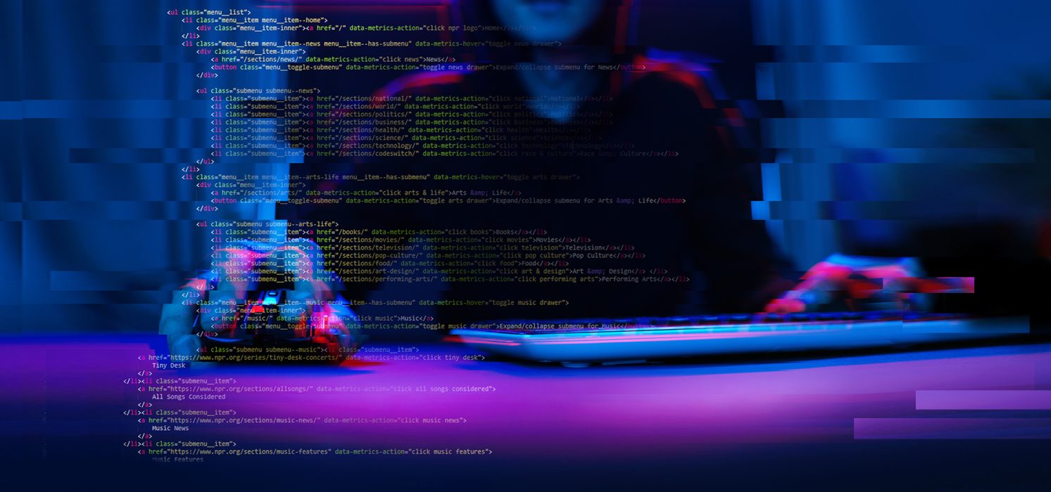 Pictorial representation of phishing campaign. A blurred image focusing on a person typing on a laptop with lines of code visible on the screen, illuminated in blue and red lights, suggestive of intense coding or cyber activities.