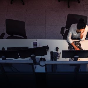 Pictorial representation of an aerial view of an individual working on a cumputer in an office setting.